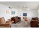 Bright living room with a ceiling fan and large windows, perfect for relaxing or entertaining guests at 10423 W Monterosa Dr, Sun City, AZ 85351