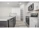 Modern kitchen with stainless steel appliances, a walk-in pantry, and a large kitchen island with a sink at 10947 W Malibu Cir, Arizona City, AZ 85123