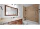 Stylish bathroom featuring tile accents and a classic vanity, complemented by a framed mirror at 111 W Missouri Ave # E, Phoenix, AZ 85013