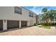 Exterior shot of a home with a large driveway, custom garage doors, and a well-manicured lawn at 111 W Missouri Ave # E, Phoenix, AZ 85013