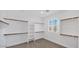 Spacious walk-in closet with built-in shelving and a window for natural light at 111 W Missouri Ave # E, Phoenix, AZ 85013