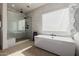 Spa-like bathroom showcasing a modern tub and glass-enclosed shower at 11143 N Mckinney St, Surprise, AZ 85388