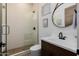 Bathroom featuring a glass-enclosed shower, modern fixtures, and a vanity with an oval mirror at 11143 N Mckinney St, Surprise, AZ 85388