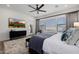 Bedroom featuring a TV, windows, and an armchair in a modern home at 11143 N Mckinney St, Surprise, AZ 85388