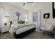 Bright bedroom with white walls, green patterned bedding, and decorative accents for a cozy retreat at 11143 N Mckinney St, Surprise, AZ 85388