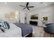 Bedroom featuring a ceiling fan, TV, and an ensuite bathroom in a modern home at 11143 N Mckinney St, Surprise, AZ 85388