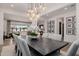 Dining area with ample seating and stylish fixtures offering a peek into the living room at 11143 N Mckinney St, Surprise, AZ 85388