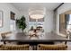 Dining room with an oversized decorative light fixture, neutral colors, and large window at 11143 N Mckinney St, Surprise, AZ 85388