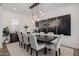 Elegant dining area with modern lighting fixture, setting the scene for sophisticated dining at 11143 N Mckinney St, Surprise, AZ 85388