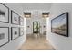 Elegant hallway leading to the fitness studio and spa, adorned with tasteful artwork and decor at 11143 N Mckinney St, Surprise, AZ 85388