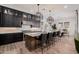 Modern kitchen with a center island, stylish lighting and seating for entertaining at 11143 N Mckinney St, Surprise, AZ 85388