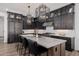 Modern kitchen featuring dark wood cabinets, white subway tile backsplash, and a spacious island with bar seating at 11143 N Mckinney St, Surprise, AZ 85388