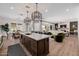 Open-concept kitchen with dark wood island, marble countertop and view of living spaces at 11143 N Mckinney St, Surprise, AZ 85388