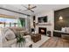 Inviting living room with a stone fireplace, wood mantel, and comfortable seating near sliding glass doors at 11143 N Mckinney St, Surprise, AZ 85388