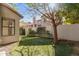 View of the artificial grass in the backyard, the cinderblock perimeter, and the patio cover at 1157 W Edgewater Dr, Gilbert, AZ 85233