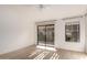 Bright and airy bedroom with light wood flooring and sliding door leading to the outdoor patio at 1157 W Edgewater Dr, Gilbert, AZ 85233