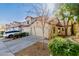 Charming townhome featuring a stucco exterior, red tile roof, and a well-maintained front yard with mature landscaping at 1157 W Edgewater Dr, Gilbert, AZ 85233