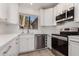 Bright kitchen with white cabinetry, stainless steel appliances, and a view from the sink at 1157 W Edgewater Dr, Gilbert, AZ 85233