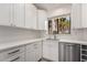 Modern kitchen featuring white cabinets, stainless steel appliances, and stone countertops at 1157 W Edgewater Dr, Gilbert, AZ 85233