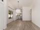 Open concept living space with light wood flooring and a modern light fixture at 1157 W Edgewater Dr, Gilbert, AZ 85233