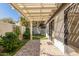 Backyard patio features brick pavers, synthetic turf, and a covered patio that connects to the home's interior at 1157 W Edgewater Dr, Gilbert, AZ 85233