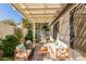 Outdoor patio under pergola with white cushioned seating, brick pavers, stainless steel BBQ and green space at 1157 W Edgewater Dr, Gilbert, AZ 85233