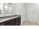 Bathroom featuring dual sinks with granite counters, dark wood cabinetry, and a shower at 11875 E Aster Ln, Florence, AZ 85132