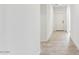 Hallway with tile flooring, white walls and white doors leading into various rooms at 11875 E Aster Ln, Florence, AZ 85132