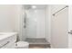 Updated bathroom featuring a glass shower, white textured tile, and modern fixtures at 13234 W Desert Glen Dr, Sun City West, AZ 85375