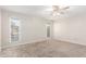 Spacious bedroom with a ceiling fan and natural light from large windows at 13234 W Desert Glen Dr, Sun City West, AZ 85375