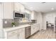 Stylish kitchen featuring stainless steel appliances, light cabinetry and subway tile backsplash at 13234 W Desert Glen Dr, Sun City West, AZ 85375