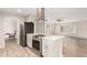 Modern kitchen and living room, featuring stainless steel appliances and an open floor plan at 13234 W Desert Glen Dr, Sun City West, AZ 85375