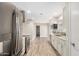 Bright kitchen with stainless steel appliances and wood-look tile flooring throughout at 13234 W Desert Glen Dr, Sun City West, AZ 85375