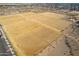 Aerial view of a vibrant community park, complete with soccer fields, sports courts, and open green spaces at 1353 N Avoca --, Mesa, AZ 85207