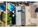 Aerial view of a well maintained backyard featuring a pool, playground, green lawn and lounge area at 1353 N Avoca --, Mesa, AZ 85207