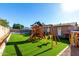 Spacious backyard featuring a playset, trampoline, and outdoor lounge area at 1353 N Avoca --, Mesa, AZ 85207