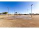 Outdoor basketball court ready for a pickup game with surrounding grassy area and lights at 1353 N Avoca --, Mesa, AZ 85207