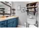 Bathroom features a vanity with granite counters and shelves for storage at 1353 N Avoca --, Mesa, AZ 85207