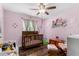 A bedroom featuring hardwood floors, a ceiling fan and soft pink walls at 1353 N Avoca --, Mesa, AZ 85207