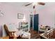 A bedroom featuring hardwood floors, a ceiling fan and soft pink walls at 1353 N Avoca --, Mesa, AZ 85207