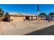 Single-story home with drought-tolerant landscaping, a two-car garage, and a welcoming entryway at 1353 N Avoca --, Mesa, AZ 85207