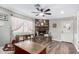 Inviting living room with a stone fireplace, wood floors, natural light, and a ceiling fan at 1353 N Avoca --, Mesa, AZ 85207