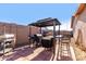 Covered patio with a black metal gazebo features a grill and seating area with paver flooring at 1353 N Avoca --, Mesa, AZ 85207