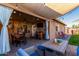 Inviting covered outdoor patio with comfortable seating, a dining area, and a bar area for entertaining guests at 1353 N Avoca --, Mesa, AZ 85207