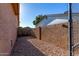 Small side yard with rock landscaping and block wall fence for privacy at 1353 N Avoca --, Mesa, AZ 85207