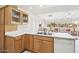 Kitchen featuring tile floors, ample countertop space, and natural wood cabinets at 13548 W Whitewood Dr, Sun City West, AZ 85375