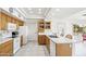 Cozy kitchen with tile flooring, white appliances, and ample cabinet space at 13548 W Whitewood Dr, Sun City West, AZ 85375