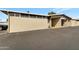 Beige brick home exterior with a covered parking area and an asphalt driveway at 13633 N 111Th Ave, Sun City, AZ 85351