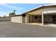 Beige brick home exterior with a covered parking area and an asphalt driveway at 13633 N 111Th Ave, Sun City, AZ 85351