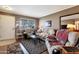 Well-lit living room with cozy seating, front door access and neutral color palette at 13633 N 111Th Ave, Sun City, AZ 85351